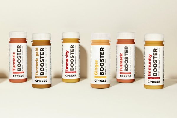 Booster bottles lined up against off-white background