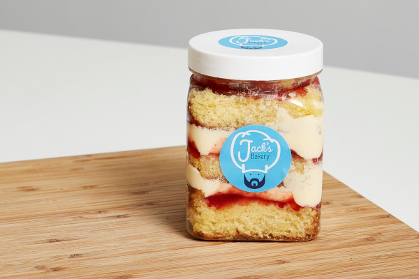 Cake in a jar on top of wooden board